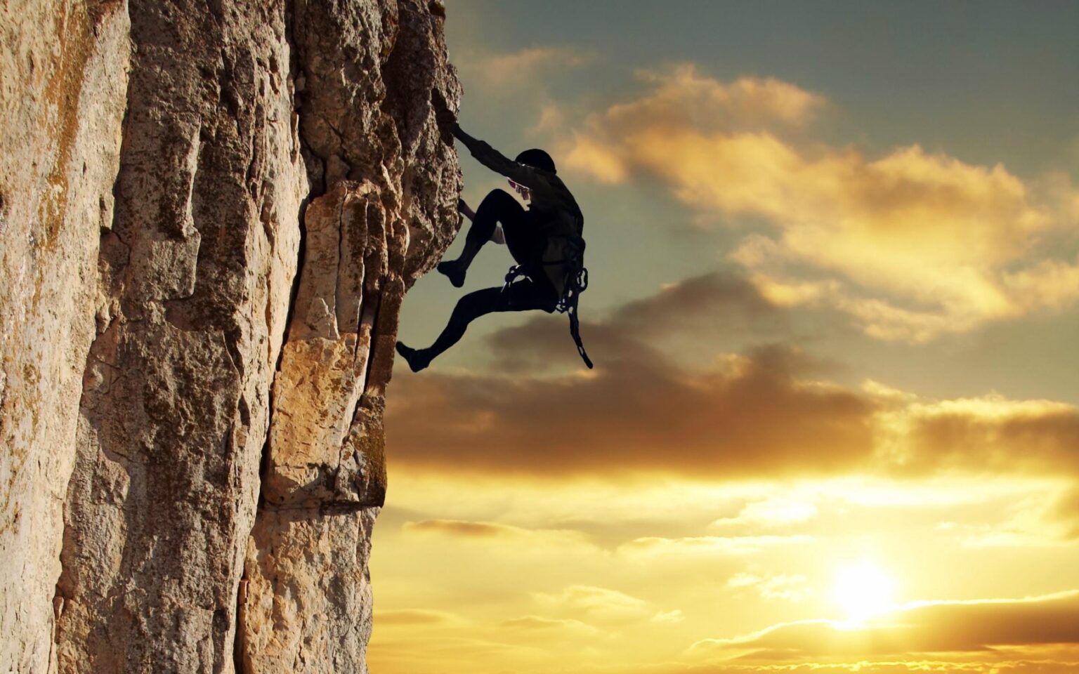 a guy climbing a rock