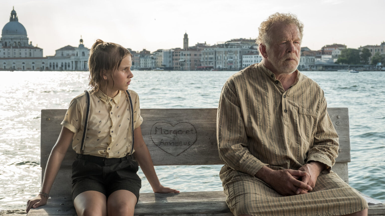 an old man sitting next to his granddaughter